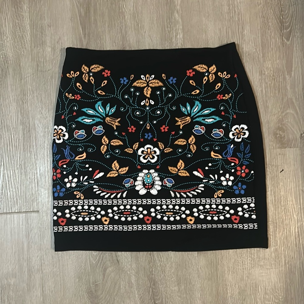 Black mini skirt with a floral print. Perfect for beginning of fall!